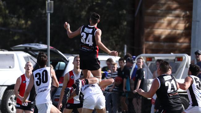 Kyle Wheatley of Watsonia flies for a mark.