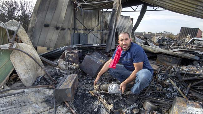 Ahmad Aljamal holds a burn winch in his damaged shed at Little River. Picture: Jay Town