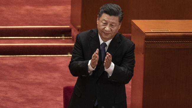 Chinese President Xi Jinping applauds veterans at a ceremony marking the 70th anniversary of China's entry into the Korean War on October 23, 2020 at the Great Hall of the People in Beijing.