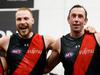 MELBOURNE, AUSTRALIA - MARCH 16: Ben McKay and Todd Goldstein of the Bombers sing the team song during the 2024 AFL Round 01 match between the Essendon Bombers and the Hawthorn Hawks at the Melbourne Cricket Ground on March 16, 2024 in Melbourne, Australia. (Photo by Dylan Burns/AFL Photos via Getty Images)