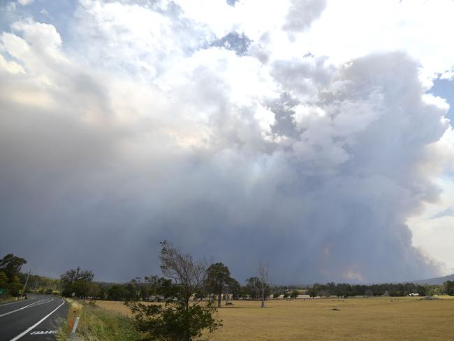 Smoke from bushfires rises high into the air as fires hit the area around the town of Nowra in the Australian state of New South Wales on December 31, 2019. - Thousands of holidaymakers and locals were forced to flee to beaches in fire-ravaged southeast Australia on December 31, as blazes ripped through popular tourist areas leaving no escape by land. Picture: Saeed Khan/AFP