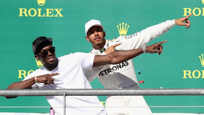 Fastest man on wheels meets fastest man in the world. Lewis Hamilton and Usain Bolt strike a pose on the podium for the US Grand Prix in 2017 in Austin Texas. Photo: Mark Thompson/Getty Images