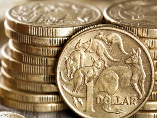 Stacks of Australian one dollar coins. Focus on front coin.