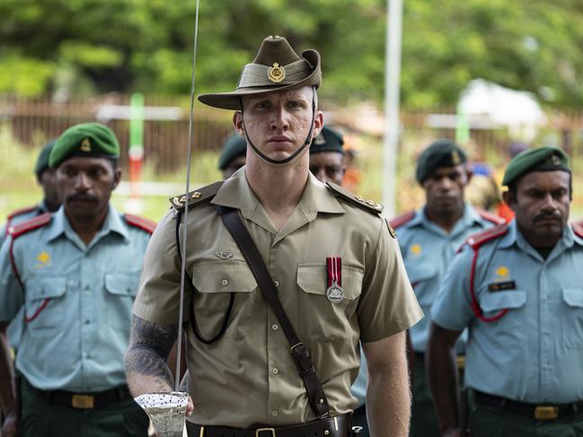 An Australian Army officer and Papua New Guinea Defence Force soldiers during a ceremonial parade to celebrate the 49th Independence Day at King Charles Oval at Wewak, Papua New Guinea. PHOTO: LCPL Riley Blennerhassett