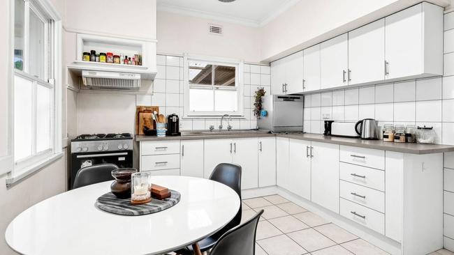 The central kitchen has updated cabinets and a gas cooker.