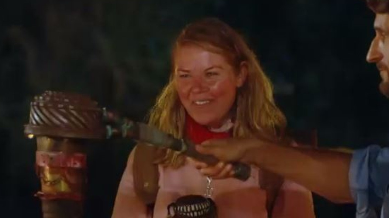 Kate’s all smiles as her torch is snuffed.