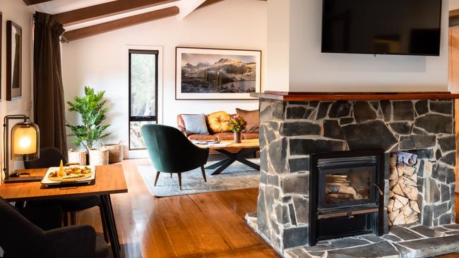 The double-sided fireplace divides the sleeping and living areas in the King Billy Suites.