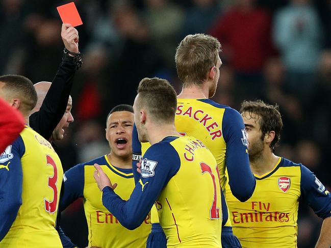 STOKE ON TRENT, ENGLAND - DECEMBER 06: Calum Chambers of Arsenal is shown a red card by Referee Anthony Taylor during the Barclays Premier League match between Stoke City and Arsenal at the Britannia Stadium on December 6, 2014 in Stoke on Trent, England. (Photo by Clive Mason/Getty Images)