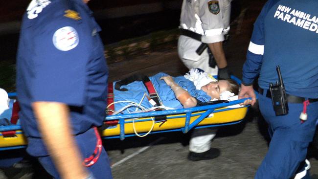 Lauren O’Neill is stretchered to an ambulance after the quick actions of neighbours, then paramedics, likely saved her life. Picture: On Scene Bondi