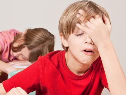 RendezView. A boy struggling to stay awake as his classmate sleeps in the desk behind him. (Pic: iStock)