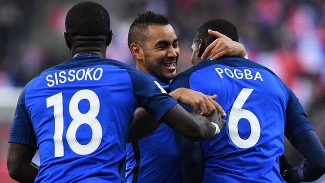 France's midfielder Paul Pogba (R) celebrates with Dimitri Payet (C).