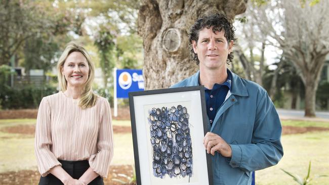 Sunrise Way CEO Louise Sanderson and artist and resident Mick Marris with one of his paintings.