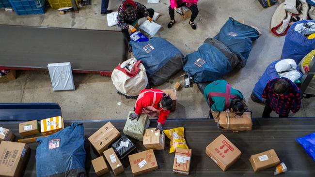 Haian Trade workers sort packages on an assembly line in Jiangsu province following the Singles Day shopping festival. Picture: Zhai Huiyong/Costfoto/Future Publishing via Getty Images