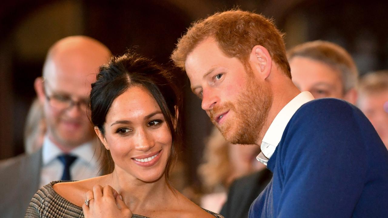 Prince Harry whispers to Meghan Markle as they watch a dance performance by Jukebox Collective in Cardiff, Wales. Picture: Ben Birchall/Getty Images