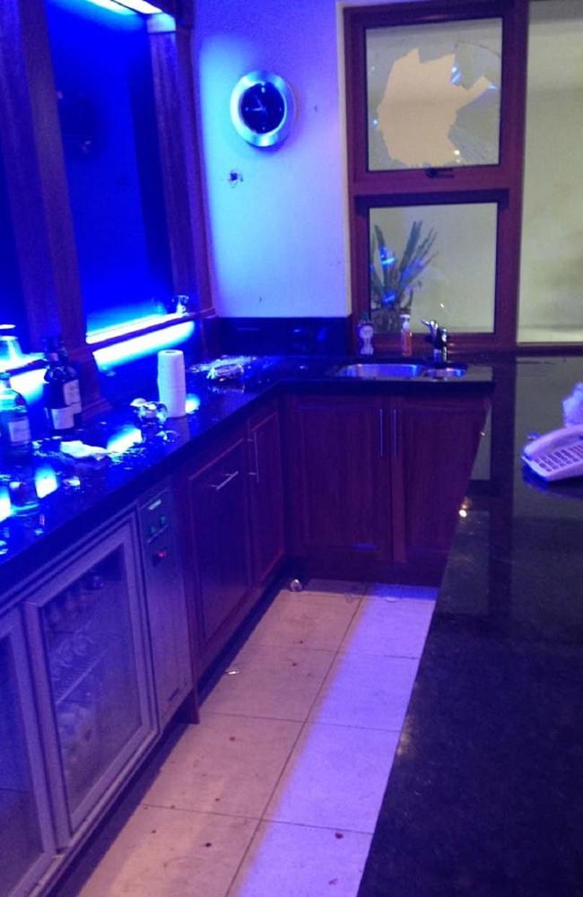 A photo submitted to court shows a smashed window and blood on the floor at an Australian mansion the former couple played in.