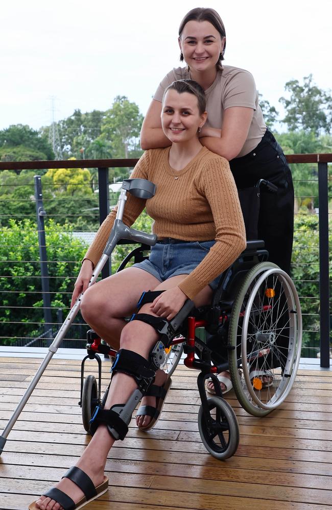 Katie Jones (seated) with her sister Rebecca at their home in Albany Creek. Picture: Tertius Pickard