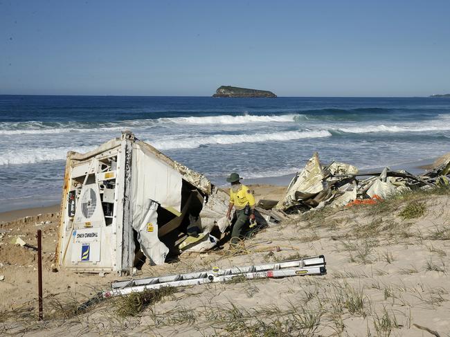 Workers salvaged the remains of five shipping containers that had washed up on Birdie Beach on the Central Coast of NSW, Thursday, May 28, 2020. The APL England cargo ship lost about 40 shipping containers in rough seas off the NSW coast. (AAP Image/Darren Pateman)