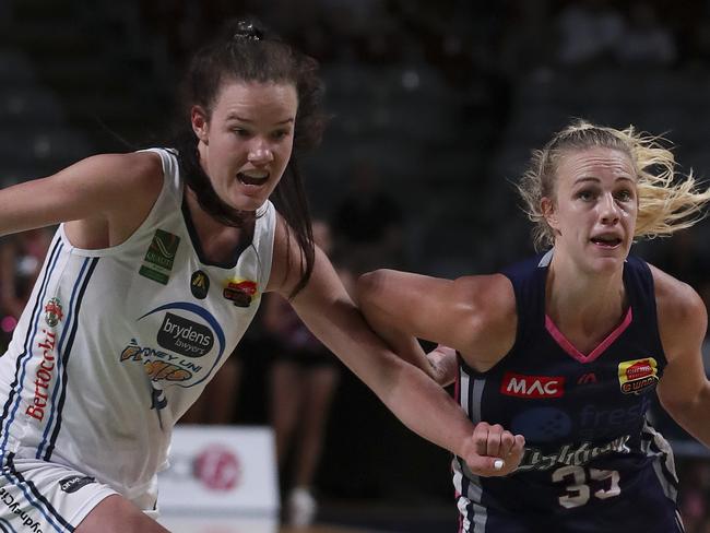 BASKETBALL - WNBL - Adelaide Lightning v Sydney Uni Flames at Titanium Security Arena. Nicole Seekamp charges to the net with Lara McSpadden. Picture SARAH REED