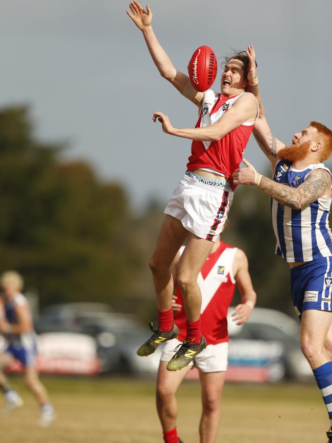 Red Hill’s Zach Vines goes up against Langwarrin’s Matt Naughton.