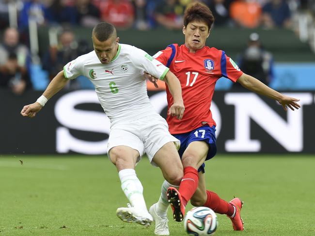 South Korea's midfielder Lee Chung-Yong challenges Algeria's defender Djamel Mesbah.