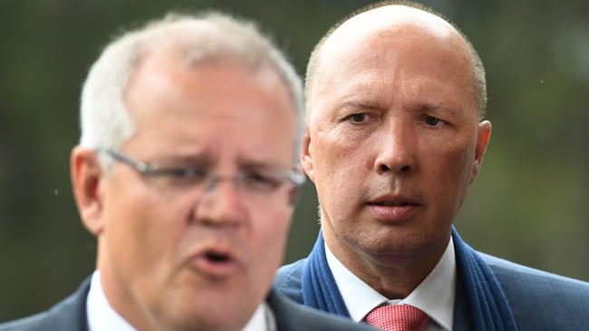 Minister for Home Affairs Peter Dutton looks at Prime Minister Scott Morrison. Picture: AAP Image/Dan Peled