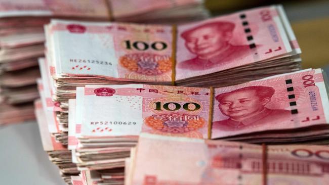 Bundles of 100 yuan notes at a bank in Shanghai. Picture: Johannes Eisele / AFP.