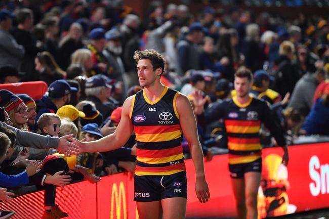 Crows Kyle Hartigan celebrates with the crowd after the Round 7 victory over the Fremantle Dockers at the Adelaide Oval. Picture: David Mariuz/AAP