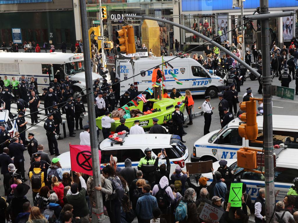 As tourists and New Yorkers watched, dozens of people were arrested as the climate change protesters blocked traffic in the busy centre of Manhattan. Picture: AFP