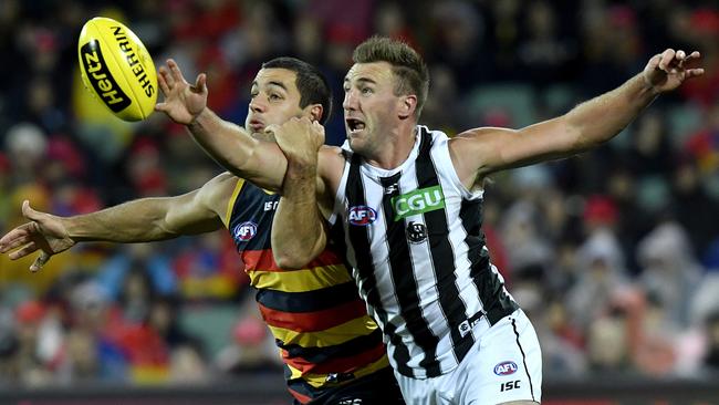 Crows captain Taylor Walker is spoiled by Collingwood’s Lynden Dunn during Friday night’s thrashing at Adelaide Oval. Picture: AAP Image