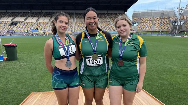 St Peters Lutheran College, Springfield student, Allira Takau, middle with her gold medal from the 17 years discus. She is joined on the podium by Danielle Philippa Jones, left, and Haley Condon.