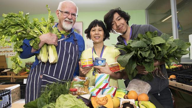 The Asylum Seeker Resource Centre food bank received a Feed Melbourne Appeal grant last year. Pictured are volunteers Brian Derum, Uyen Nguyen and Dave Hu. Picture: Ellen Smith