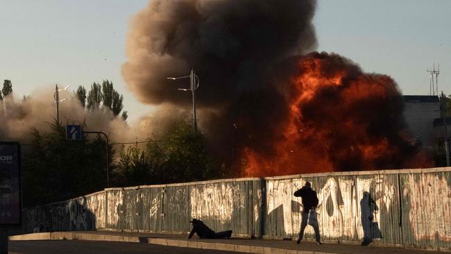 A man falls to the ground following a drone attack in Kyiv on Monday. Picture: AFP