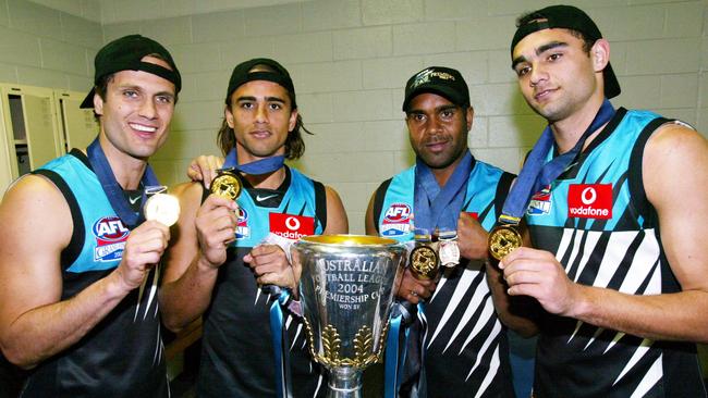 Port’s indigenous players with the cup with Gavin Wanganeen, Peter Burgoyne, Byron Pickett and Shaun Burgoyne.