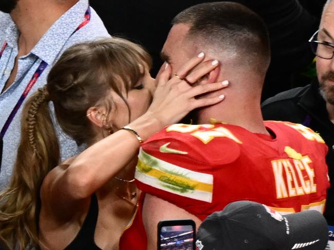 US singer-songwriter Taylor Swift kisses Kansas City Chiefs' tight end #87 Travis Kelce after the Chiefs won Super Bowl LVIII against the San Francisco 49ers at Allegiant Stadium in Las Vegas, Nevada, February 11, 2024. (Photo by Patrick T. Fallon / AFP)