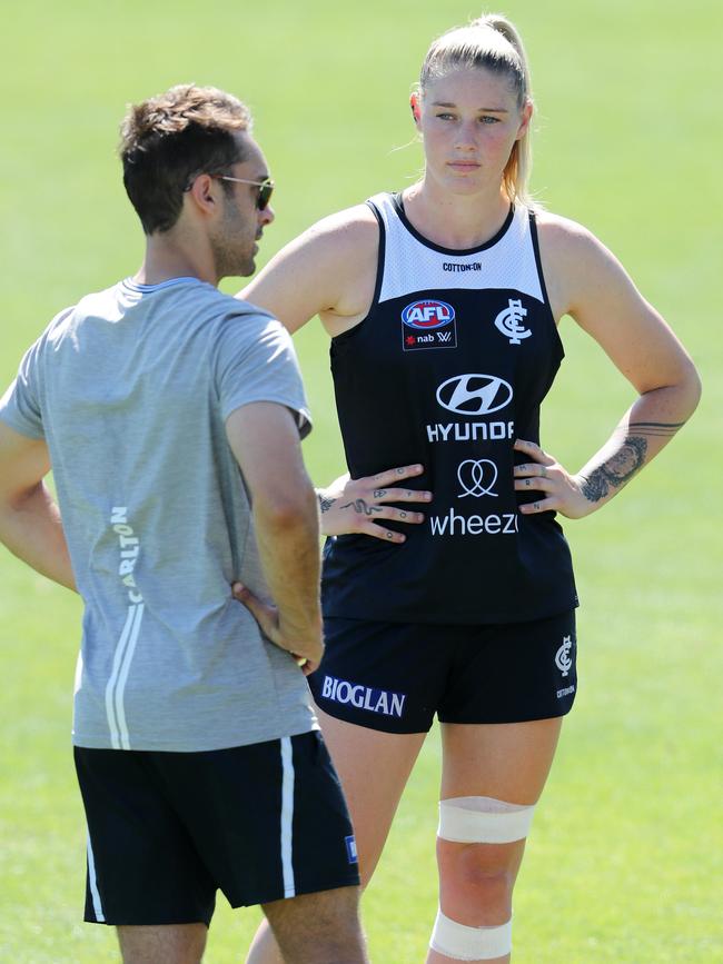 Tayla Harris talks with a medico before leaving the track early. Picture: Michael Klein