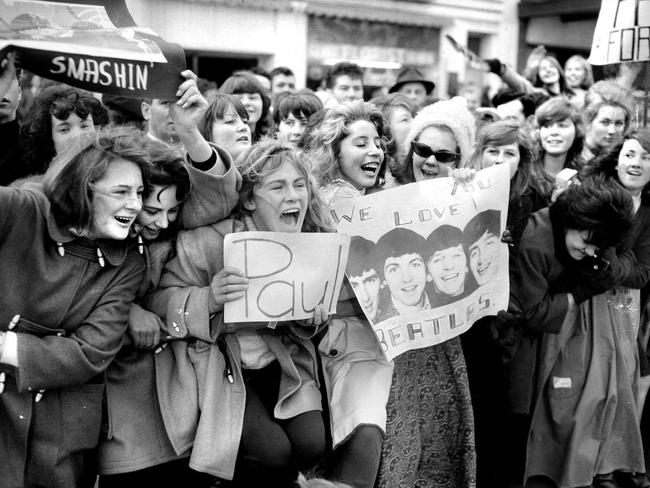 June 14, 1964: Many of the screaming teenage fans had made their own welcome signs. Picture: Herald Sun Image Library