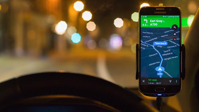 Edinburgh, UK - April 19, 2016:  Google Maps Navigation software running as an app on a Samsung S6 smartphone, mounted above a car dashboard to provide driving directions.