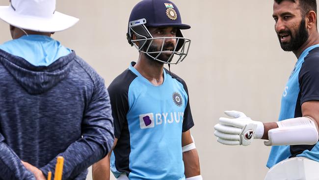 India captain Ajinkya Rahane, speaking with Cheteshwar Pujara, has refused to guarantee his side willtravel to Brisbane. Picture: AFP