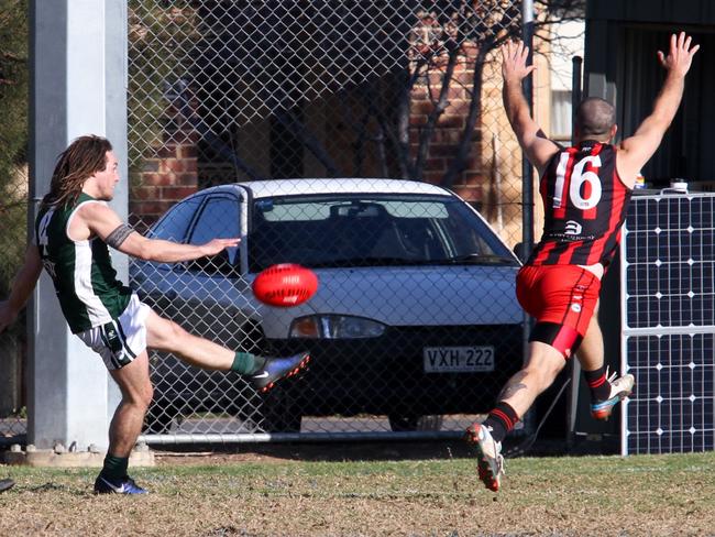 Seaton’s Shane Harris gets his kick away against Plympton in a match last year. Picture: Jayson Vowles.