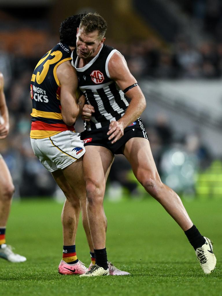 Izak Rankine of the Crows is knocked out by a late hit from Dan Houston of the Power. Picture: Mark Brake/Getty Images