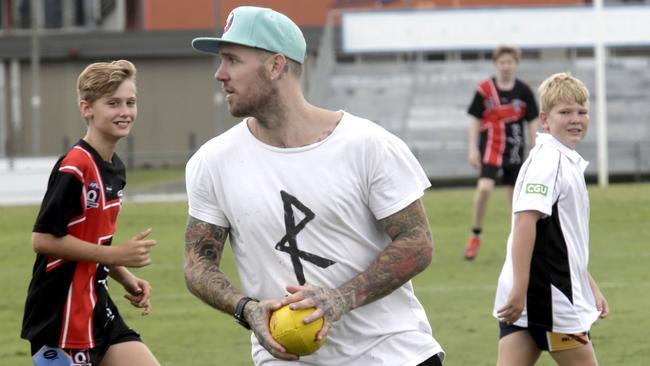 Former on-field champion Dane Swan works with kids in footy clinics. Picture: Anna Rogers