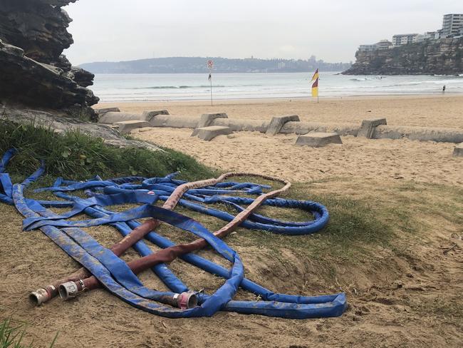 A pile of hoses left beside the track leading to the northern end of Freshwater Beach Picture: Jim O'Rourke