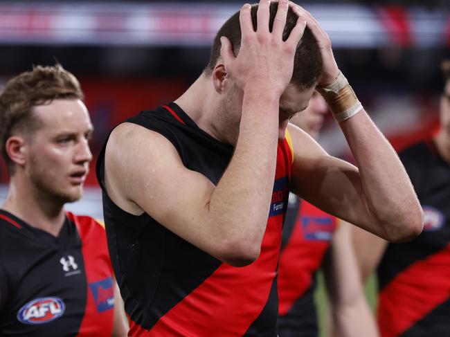 MELBOURNE, AUSTRALIA - JULY 21: Dejected Essendon players walk from the ground after the round 19 AFL match between Essendon Bombers and Western Bulldogs at Marvel Stadium, on July 21, 2023, in Melbourne, Australia. (Photo by Darrian Traynor/Getty Images)