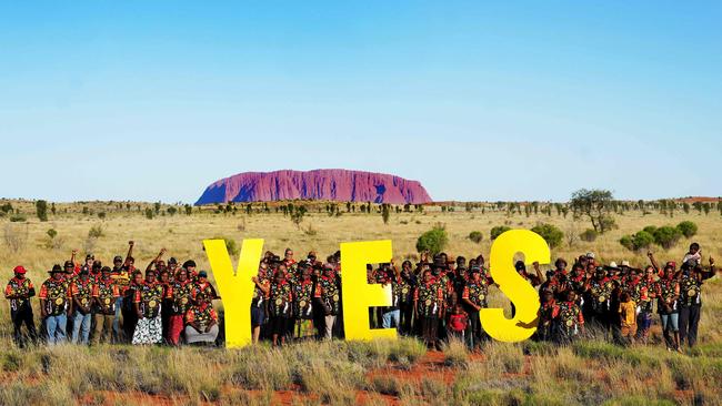 A handout photograph taken on October 3 and released by the Central Land Council shows the elected grassroots representatives of remote communities in Central Australia posing in front of Uluru. Picture: AFP