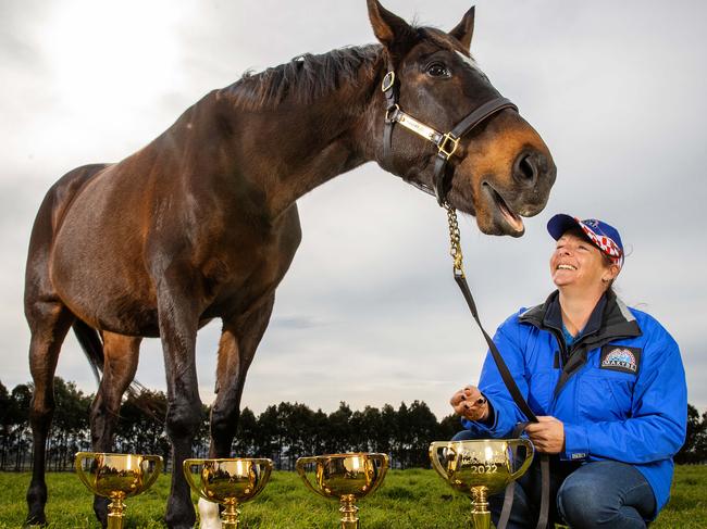 *HOLD FOR JUNE 8* MELBOURNE, JUNE 3, 2022: Three-time Melbourne Cup winner Makybe Diva pictured with her strapper Natalie Hinchcliffe, with her three Melbourne Cup trophies and the 2022 Lexus Melbourne Cup trophy. Picture: Mark Stewart