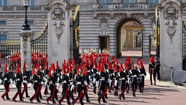 The Life Guard dismounted detachment of the Household Cavalry and the Dismounted detachment of the Blues and Royals are seen entering the gates of Buckingham Palace ahead of the procession for the Lying-in State of Queen Elizabeth II (Photo by Leon Neal/Getty Images)