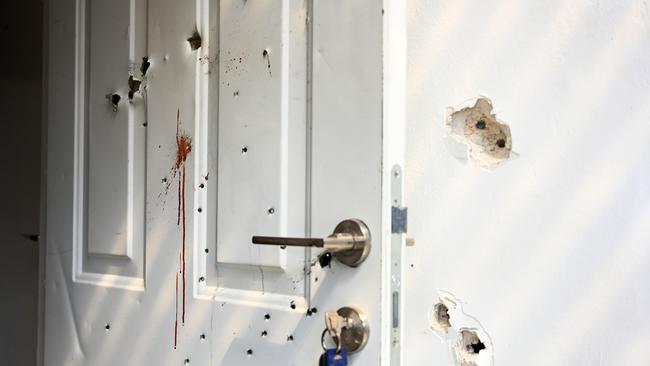 Gunshots and blood stains are seen on a door and walls of a house where civilians were killed on this kibbutz near the border with Gaza. Picture: Getty Images