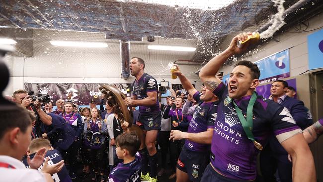 Melbourne's Cameron Smith, Cooper Cronk and Billy Slater sing the team song after the Storm’s premiership win in 2018. Picture: Brett Costello