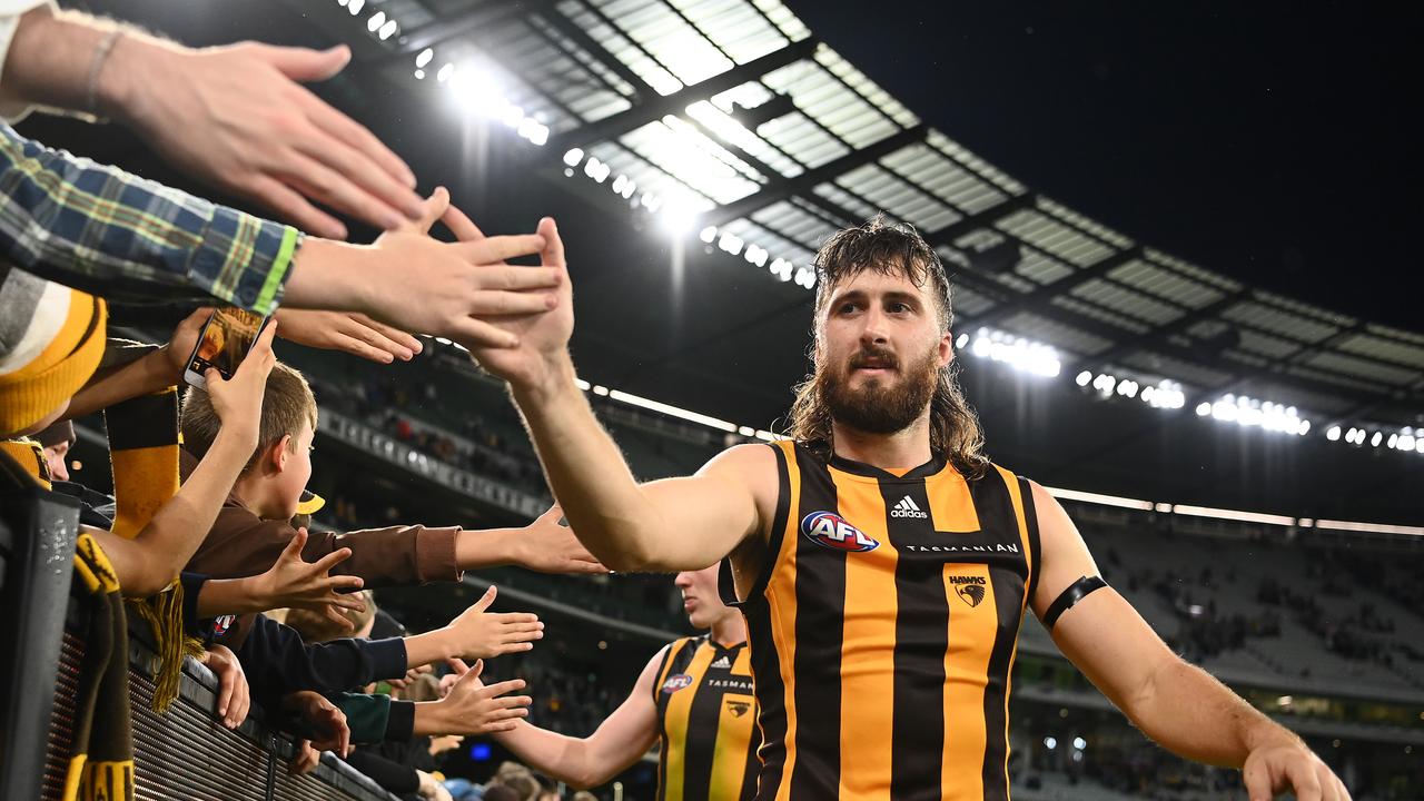 MELBOURNE, AUSTRALIA - APRIL 18: Tom Phillips of the Hawks high fives fans after winning the round five AFL match between the Hawthorn Hawks and the Geelong Cats at Melbourne Cricket Ground on April 18, 2022 in Melbourne, Australia. (Photo by Quinn Rooney/Getty Images)