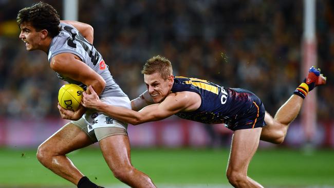 Port Adelaide’s Riley Bonner is tackled by Adelaide’s David Mackay in last year’s Showdown in July. Picture: Mark Brake/Getty Images